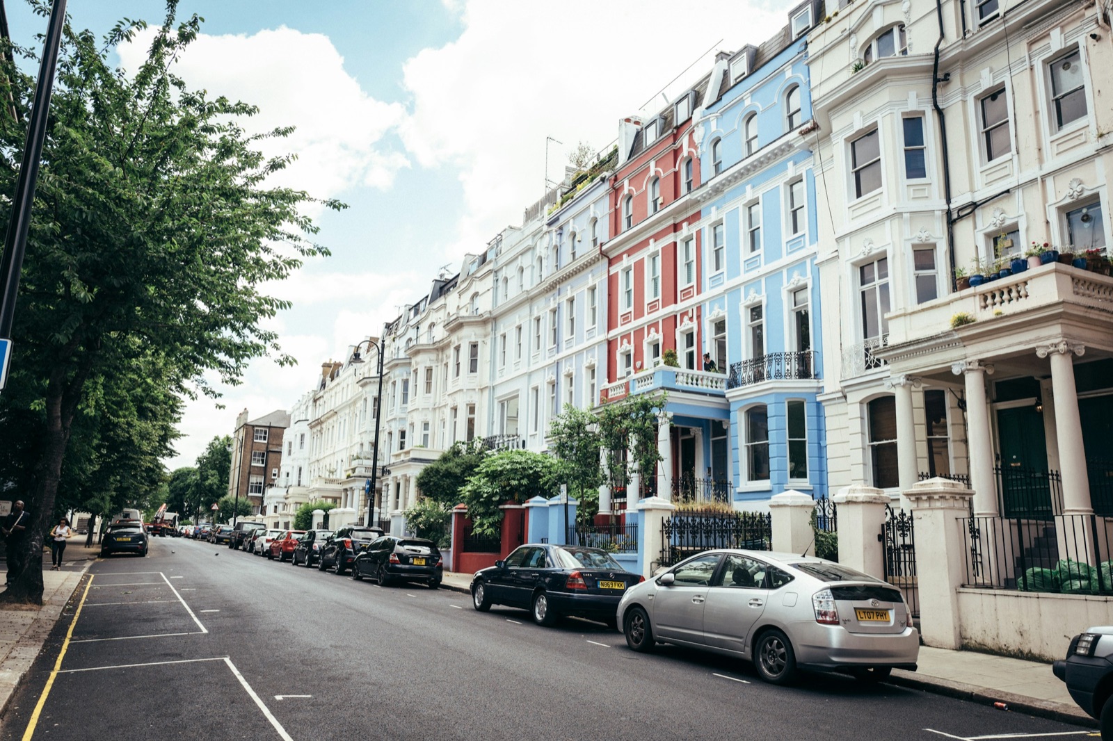 A street of white stucco terraced houses in London